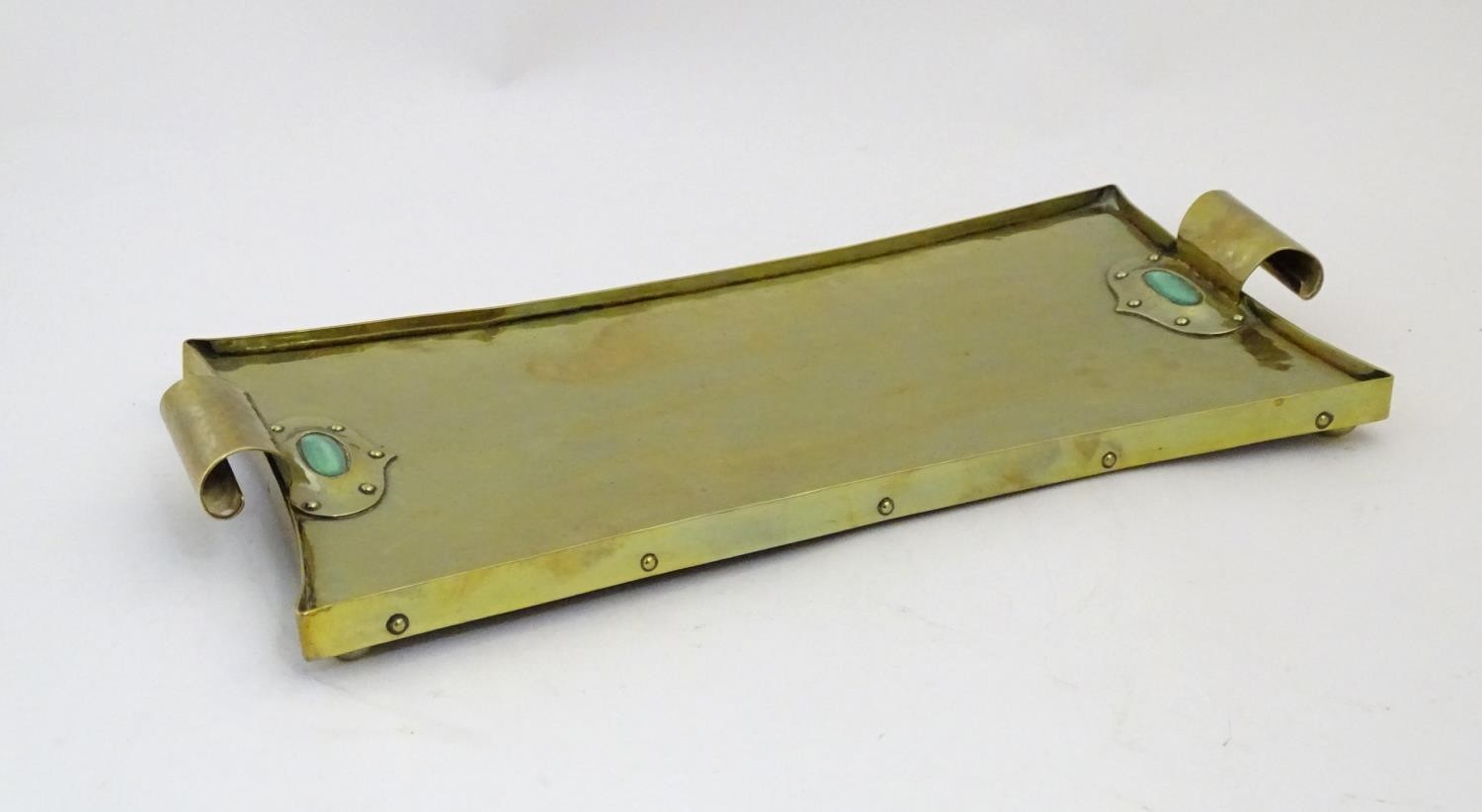 An Arts & Crafts brass tray with twin scroll handles and Ruskin style cabochon and rivet detail. - Image 4 of 9