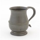 An Arts & Crafts Liberty & Co. Tudric pewter tankard with hammered decoration, in the manner of
