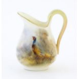 A small Royal Worcester jug with hand painted decoration depicting a pheasant, signed Jas Stinton.