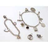 A silver charm bracelet set with various silver and white metal charms to include lion, teapot,