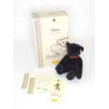 Toy: A Steiff limited edition black mohair teddy bear with jointed limbs, growler and red leather