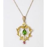 A 9ct gold Art Nouveau pendant set with red white and green stones on an 18'' long chain Please Note