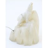 An Art Deco figural table lamp, constructed from carved alabaster and formed as a polar bear on an