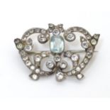 A vintage brooch set with blue and white paste stones. Approx 1 1/2" wide Please Note - we do not