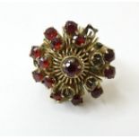 A yellow metal ring marked 18k set with garnets. Ring size approx. I 1/2 Please Note - we do not