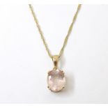 A 9ct gold pendant set with facet cut rose coloured quartz on a 9ct gold chain. Pendant approx. 3/4"