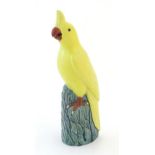 A Chinese model of a yellow cockatiel style bird. Impressed marks under. Approx. 9 3/4" high