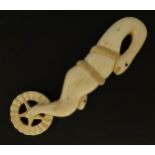 A late 19th / early 20thC carved bone pastry crimper / crimping wheel, the handle modelled as two
