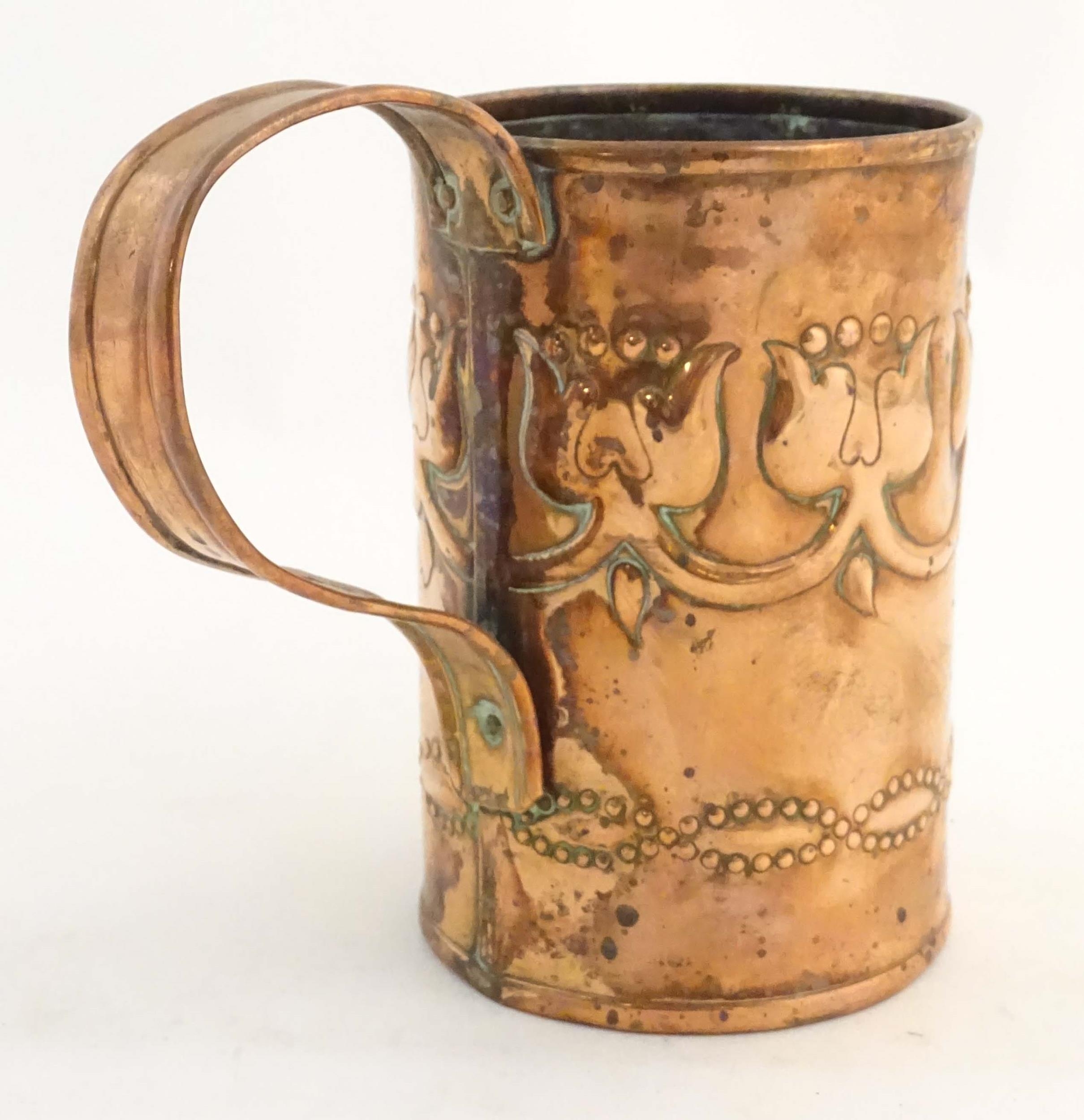 An Art Nouveau copper tankard with loop handle, decorated with embossed floral decoration and banded - Image 5 of 8