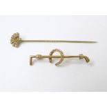 A yellow metal hunting stock pin formed as riding crop and horse shoe, together with a gilt metal