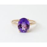A 9ct gold ring set with central amethyst. Ring size approx. P Please Note - we do not make