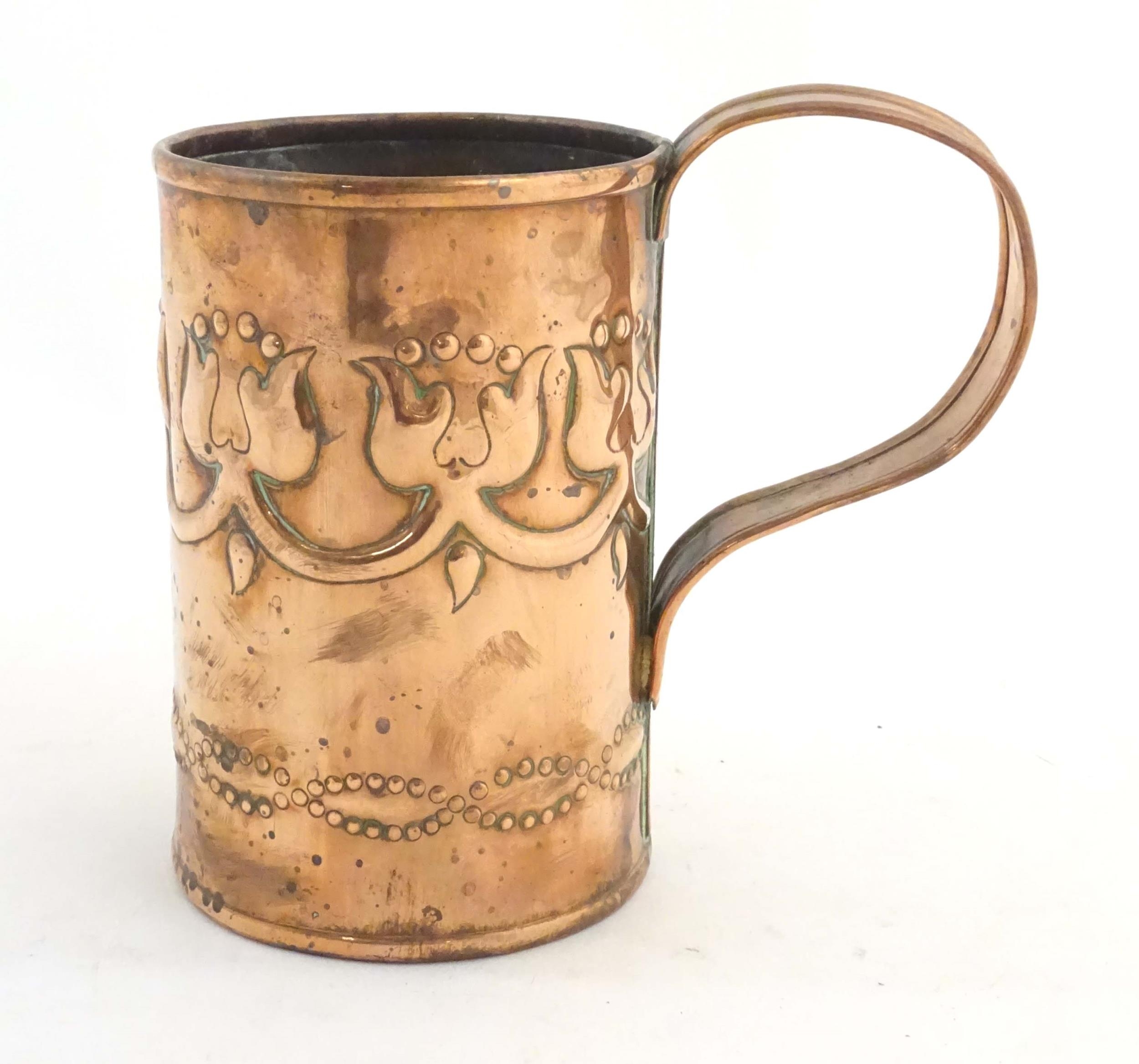 An Art Nouveau copper tankard with loop handle, decorated with embossed floral decoration and banded - Image 3 of 8