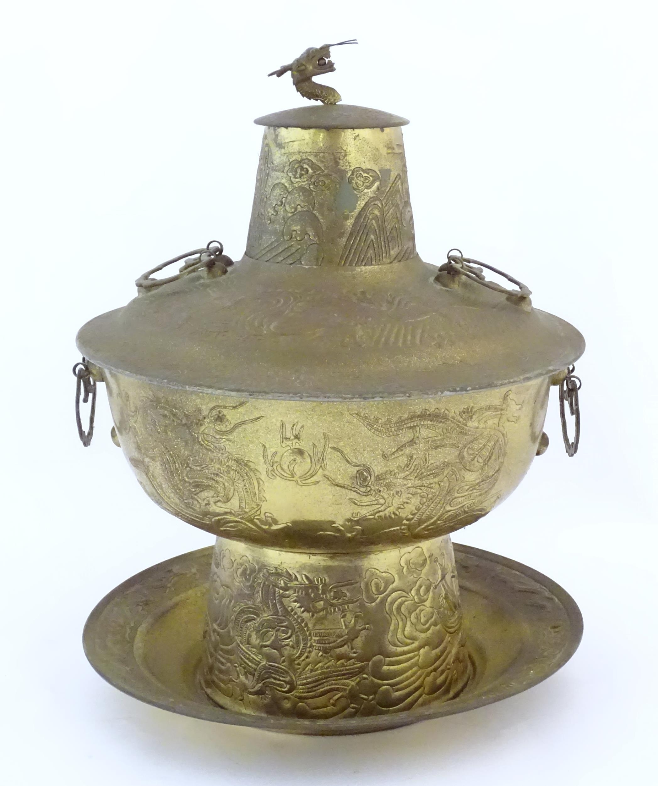 A Chinese cast metal twin handled warming / steaming pot comprising, stand, burner section, bowl,