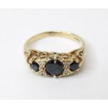 A 9ct gold ring set with sapphires and diamonds. Ring size approx. L 1/2 Please Note - we do not
