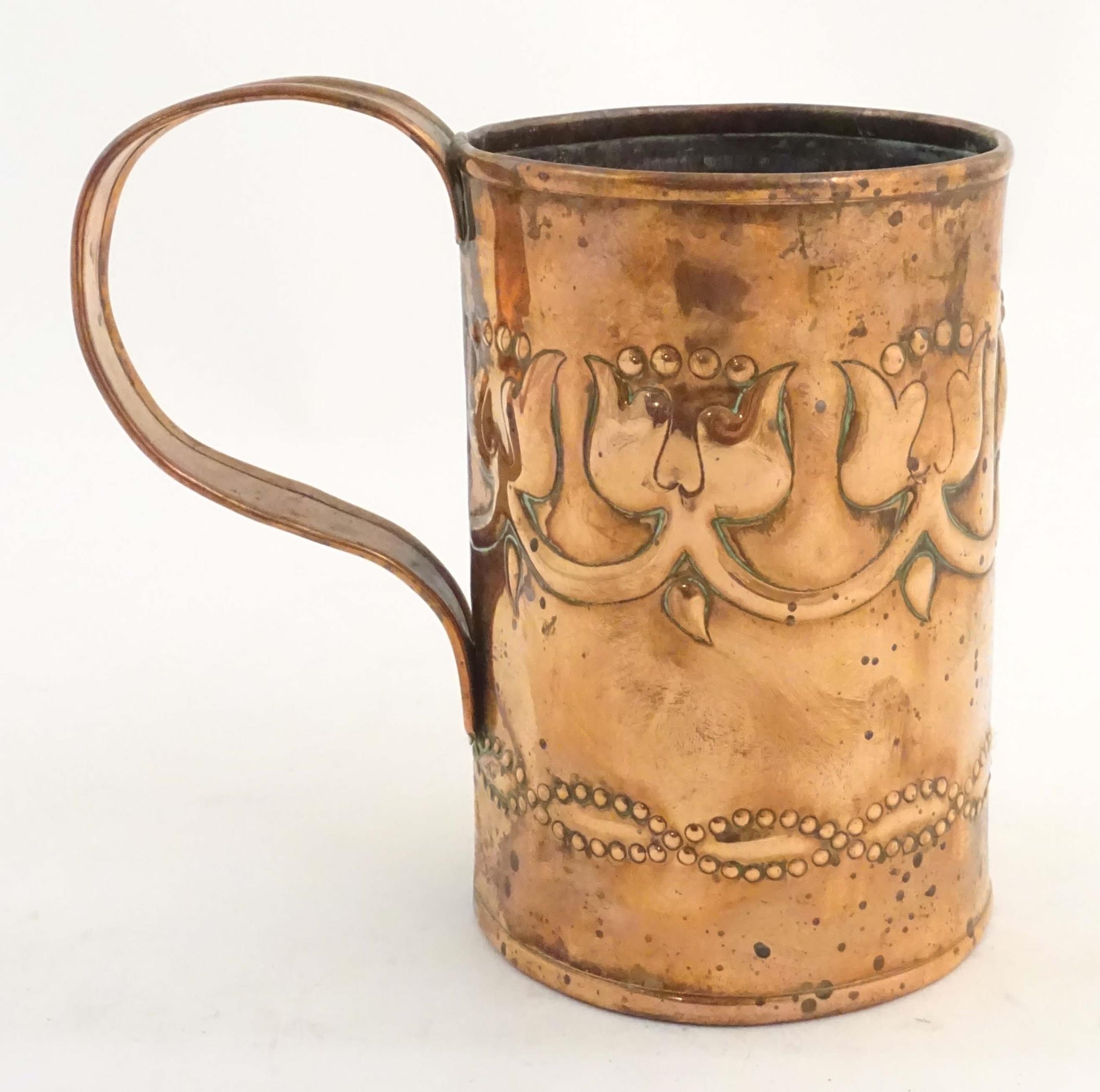 An Art Nouveau copper tankard with loop handle, decorated with embossed floral decoration and banded - Image 6 of 8