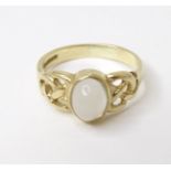 A 9ct gold ring set with central moonstone cabochon. Ring size approx. L Please Note - we do not