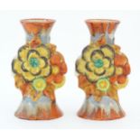 A pair of Clarice Cliff candlesticks in the My Garden pattern, decorated with flowers and foliage.