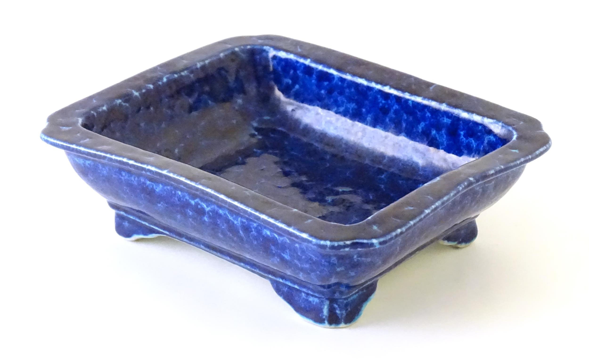 A Chinese dish of rectangular form with a blue glaze, raised on four feet. Character marks under. - Image 4 of 8