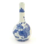 A Chinese blue and white bottle vase decorated with a scholar and two attendants in a garden.