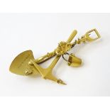 A 15ct gold brooch formed as a gold prospector's spade, axe and bucket with gold nugget detail and