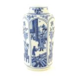A Chinese blue and white vase with panelled decoration depicting flowers and figures. Marked with
