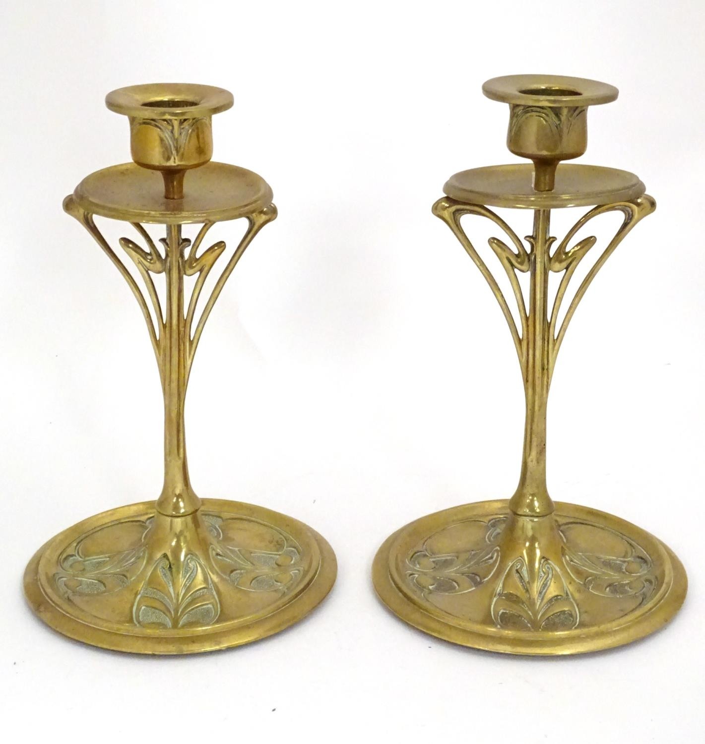 A pair of Art Nouveau brass candlesticks with tendril detail. Approx. 8 1/2" high (2) Please