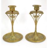 A pair of Art Nouveau brass candlesticks with tendril detail. Approx. 8 1/2" high (2) Please