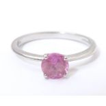 A platinum ring set with pink sapphire solitaire. Ring size approx. O Please Note - we do not make