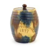 A Scottish biscuit jar and cover of barrel form marked Mrs Hutcheon 1897, by Seaton Pottery. Approx.