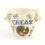 A 20thC twin handled cream / milk pail decorated with a vignette depicting a landscape scene with