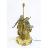 A mid 20thC table lamp, of metal construction and decorated with two singing maidens standing on a