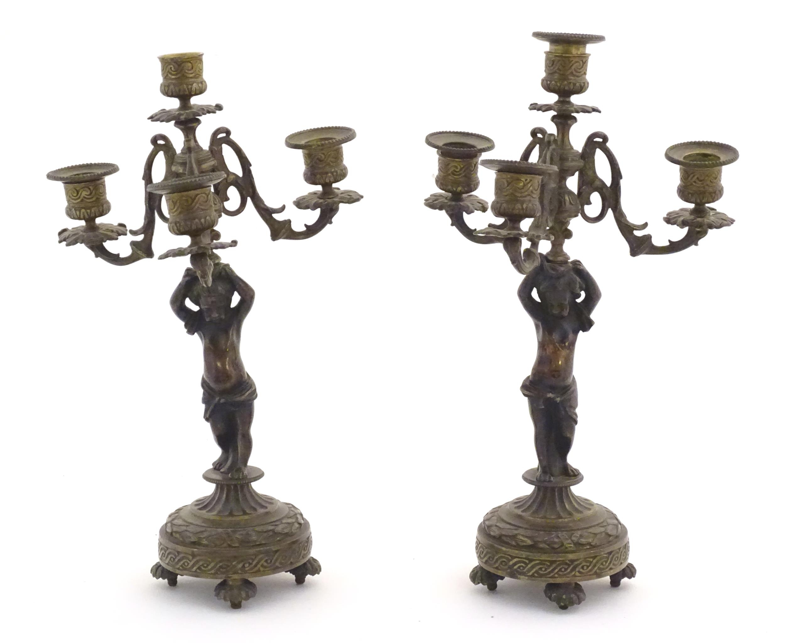 Two 19thC cast metal table candelabra / candelabrum the central bronze columns form as cherubs