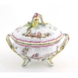 A French lidded tureen with foliate formed handles and standing on four out swept feet, the lid with