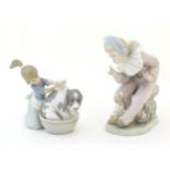 A Lladro model Bashful Bather, no. 5455, depicting a girl washing a dog. Together with a Nao