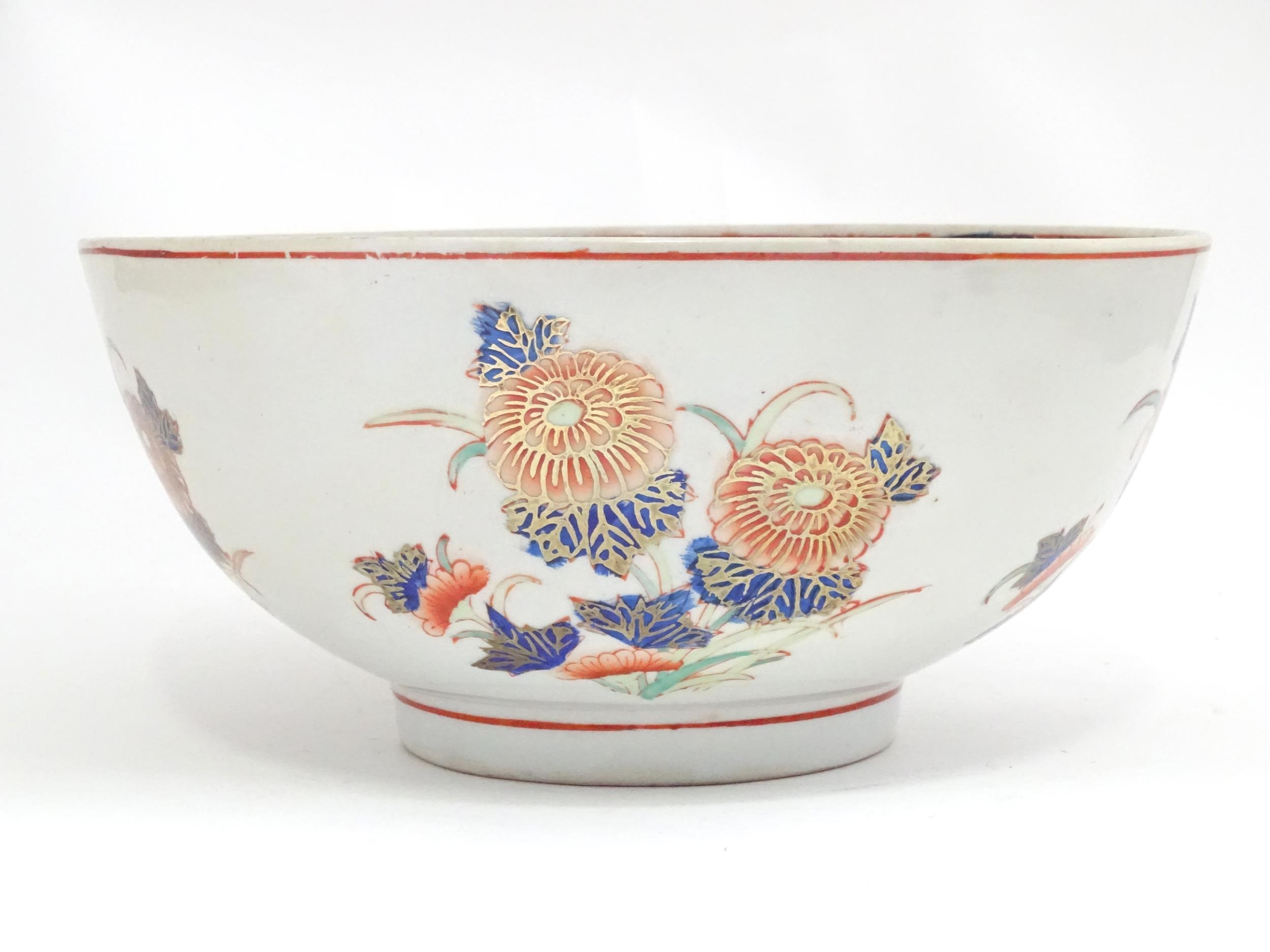 An Oriental bowl decorated with flowers and foliate in the Imari palette. Marked under. Approx. 4 - Image 4 of 6
