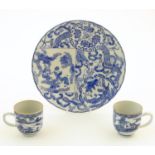 An Oriental blue and white plate decorated with figures and scrolling flowers and foliage. With blue