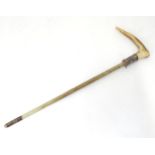 A mid 20thC riding crop mount, with antler handle, silver collar and fibreglass core. Approx 20 1/4"