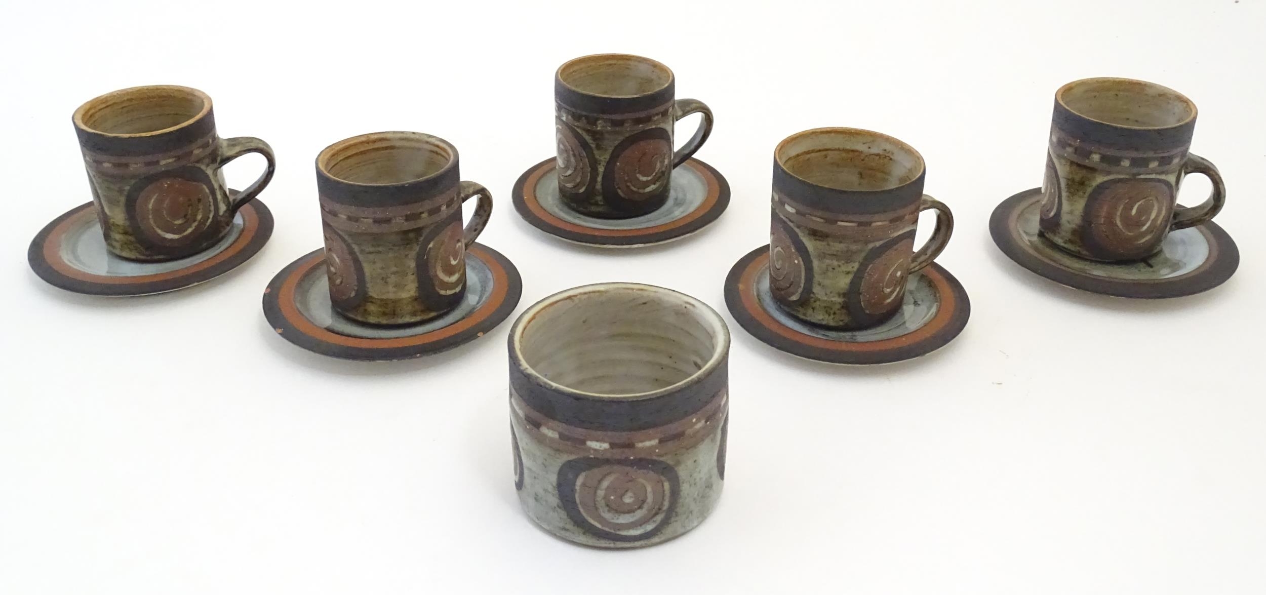 Five Briglin studio pottery coffee cups and saucers, together with a sugar bowl. Cups approx. 3"