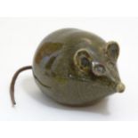 A 20thC studio pottery model of a mouse with a leather tail. Impressed maker's mark under. Approx. 3