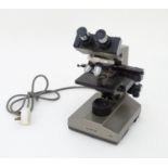 An Olympus CH microscope, stamped with serial number 249767, standing 14 3/8" tall, 7 1/2" wide,