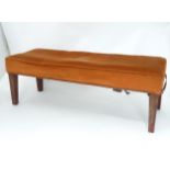 A rectangular foot stool on four tapering legs. Approx 37" long x 13" wide x 12" Please Note - we do