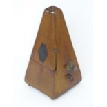 An early 20thC Maelzel Metronome, of pyramidal form and constructed from walnut, standing 9" tall