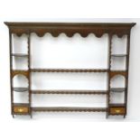 A Georgian oak plate rack with moulded cornice above dental carved frieze. Approx 70" wide x 57"