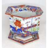 A hexagonal jardiniere / planter and stand with Chinese style decoration with flowers and foliage.