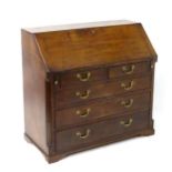 A large late 18thC mahogany bureau, having a fall front opening to show a fitted interior above