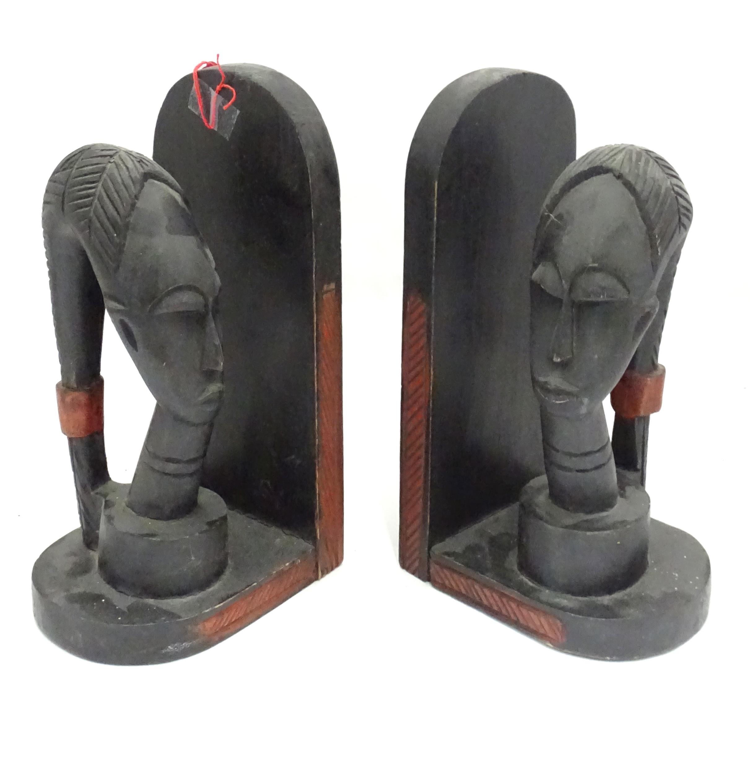 A pair of African carved hardwood bookends with figural head detail. Please Note - we do not make