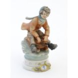 A Continental figure modelled as a boy on sledge. With Capodimonte style mark to base and