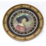 A framed hand painted ceramic plate depicting a boy in 17thC dress. Please Note - we do not make