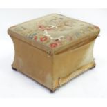 A 20thC Ottoman with needlework top and lift lid above a concave shaped base and raised on squat bun