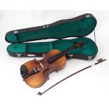 A late 20thC 3/4 size student's violin, cased with bow and accessories, approx 20 1/2" long Please